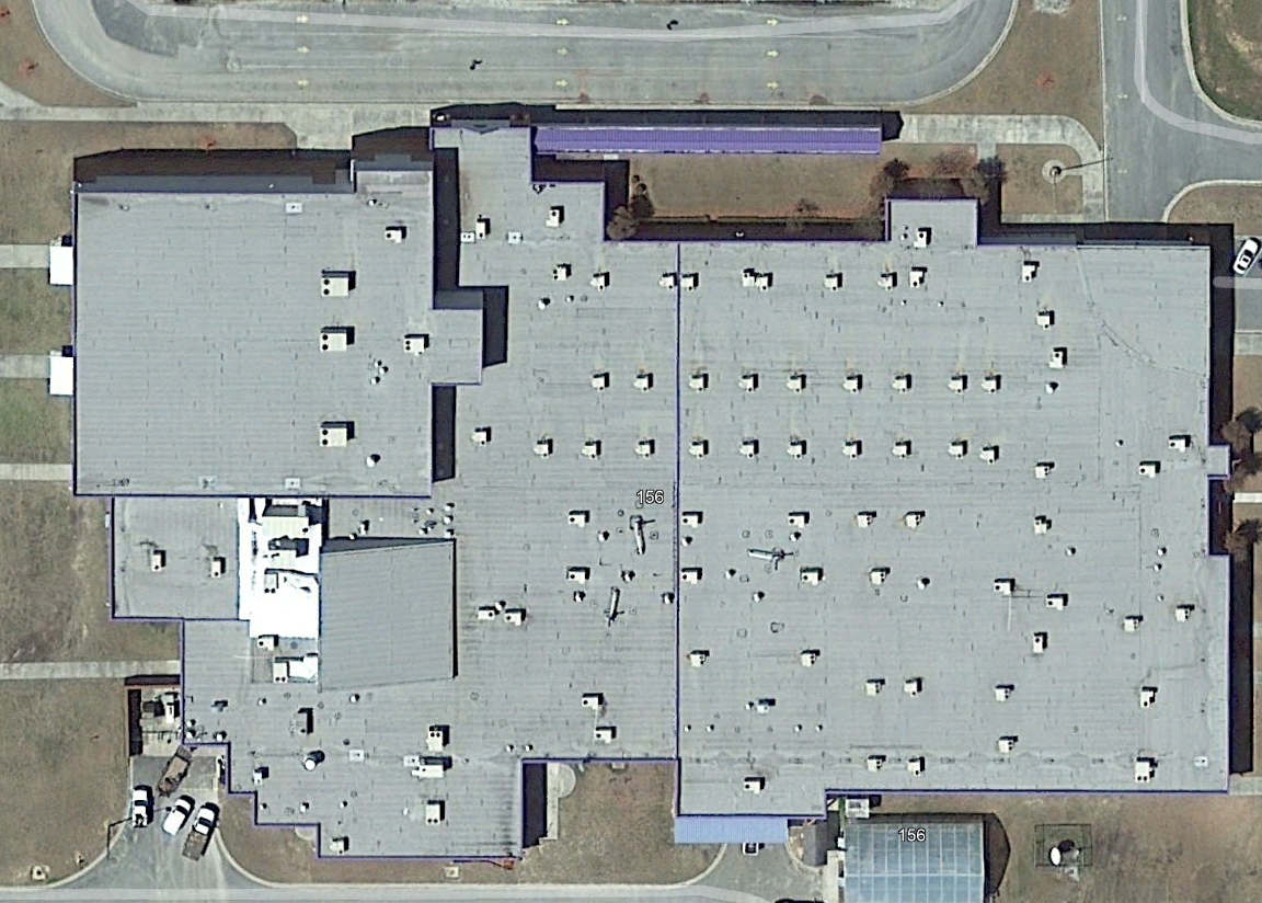 Commercial roof before ASTEC restoration — aged, patched, and weathered membrane