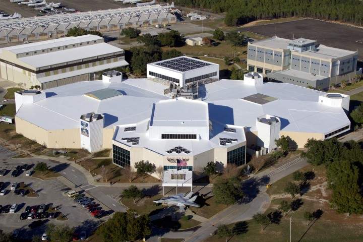 Aerial view of a commercial building with a restored white roof